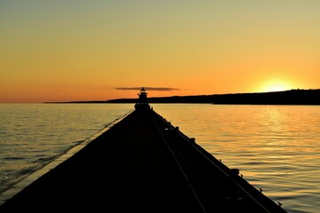 Obraz na płótnie Canvas sunset on the lighthouse pier