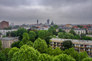 Leipzig Skyline - Downtown meets Park Drone Aerial Shot - Short before Rain - gray Sky, Green Trees