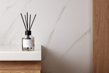 Aromatic reed air freshener on white table indoors, space for text - obrazy, fototapety, plakaty