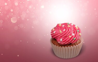 Chocolate cupcake decorated with icing and sprinkles