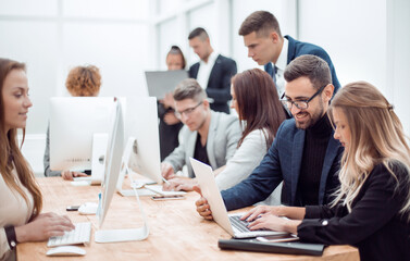 professional employees work on computers in a modern office