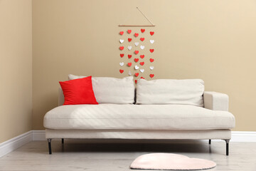 Cozy living room decorated for Valentine's Day with paper hearts. Interior design