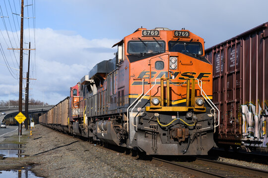 Everett, WA, USA - February 21, 2022; BNSF freight train carrying coal passes northbound through Everett