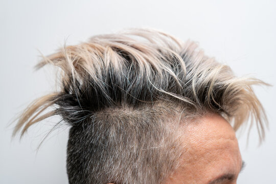 Undercut hairstyle with highlighted hair on a woman's head. Close up. Stylish hairstyle.