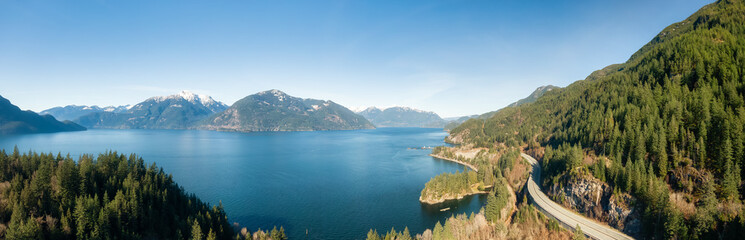 Fototapeta na wymiar Aerial Panoramic View of Sea to Sky Highway on Pacific Ocean West Coast. Sunny Winter Day. Located in Howe Sound between Vancouver and Squamish, British Columbia, Canada.