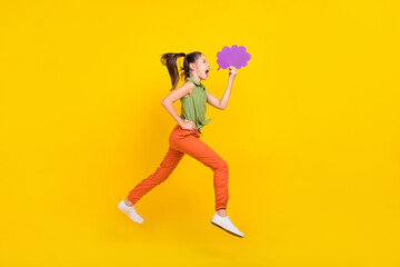 Fototapeta na wymiar Photo of excited funny student girl wear green shirt smiling jumping high running fast mind cloud empty space isolated yellow color background