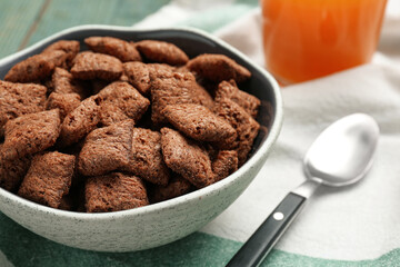 Bowl of sweet crispy corn pads on kitchen towel, closeup. Breakfast cereal