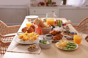 Dishes with different food on table in room. Luxury brunch