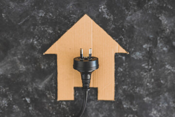 house icon on black with Australian plug on it, electricity bill and power companies