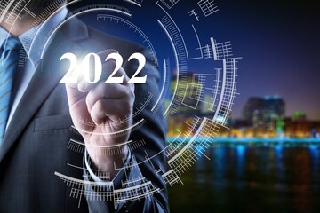 Smart businessman pointing digital dashboard in 2022 on hologram background.