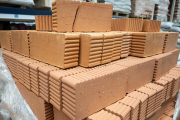 Red bricks stocked in store. Buildings construction material