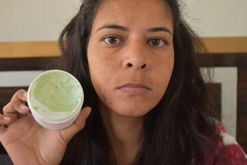 Indian Woman showing Neem face mask for acne skin