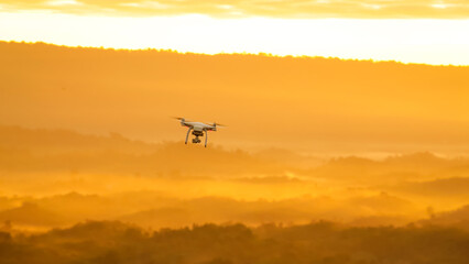 flying drone on mountain at beautiful sunrise