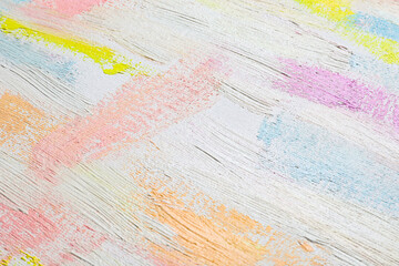 Obraz premium Strokes of different pastel acrylic paints on white canvas, closeup