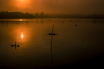 The background of the sea by the evening sea, with natural beauty (sea water, rocks, sky) and fishermen are fishing by the river bank, is a pleasure during travel.