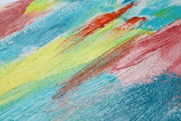 Strokes of colorful acrylic paints on canvas, closeup