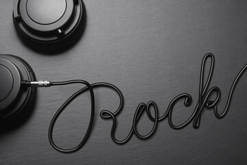 Headphones with Rock word shaped wire on black slate