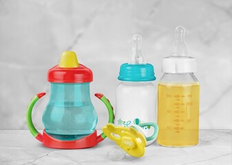 Bottles of milk for baby on table in kitchen