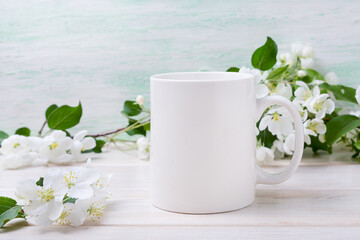 White coffee mug mockup with tender apple blossom