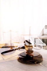 Partial view of lawyers in suits working together on project at workplace with gavel and laptop in office