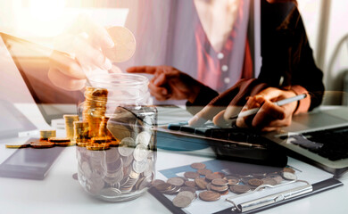 businessman working on desk office with using a calculator to calculate the numbers, finance accounting concept