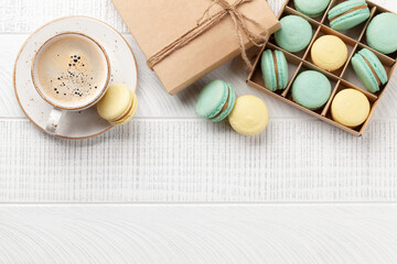 Homemade macaroons in gift box and coffee