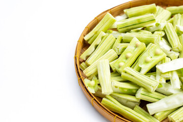 Moringa oleifera cut in pieces in bamboo weave plate on white background.