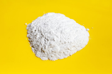 Baking soda on yellow background.