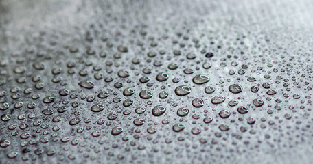 Water drops on an abstract surface. Wallpaper on the wall with blur