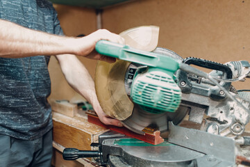 Framing Workshop. Sawing circular saw baguette handmade picture frame at studio.