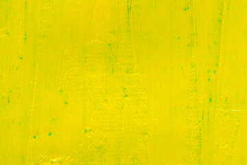 abstract bright colored background: yellow paint on blue fabric close
