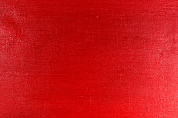 bright red background: thick acrylic paint in an uneven layer on a flat surface, light and dark areas