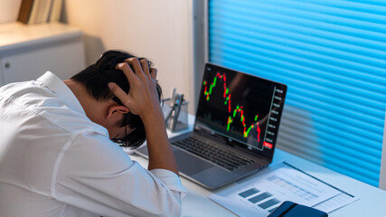 Overwork Concept The male who works in the office holding his head with stressful emotion