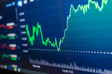 Stock market success chart on the screen. Selective focus.