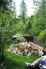 Firewood in a pallet. Chopped firewood lies on the ground. Wooden background..