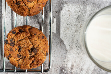 Homemade cookies with raisins, chocolate, nuts and milk on a wooden table and a art phone. Breakfast. Close up.