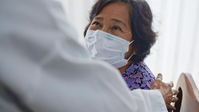 Doctor Giving Emotional Support To A Senior Patient With Disposable Medical Mask ,Slow Motion