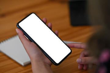 Woman hand holding and pointing on screen of smart phone.