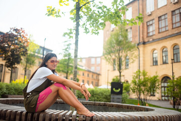 Young woman on a park bench posing at the camera