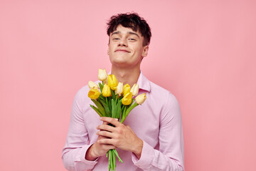 A young man bouquet of flowers date romance posing isolated background unaltered