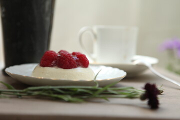 panna cotta with raspberries and a cup of coffee