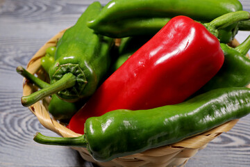 red and green peppers on a wooden table
