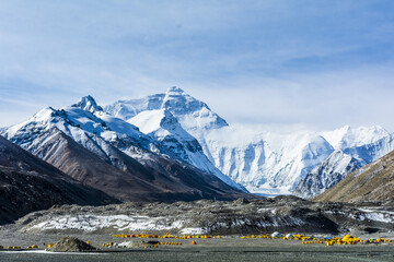 A beautiful landscape view of snowy mountains against a blue sky on the horizon