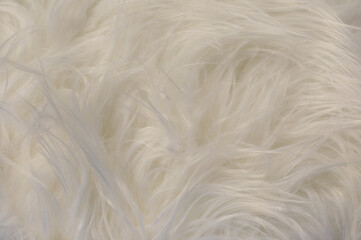 Texture of white fur, long fibers of faux fur, wool and hair. Fur blanket, warm cape for the interior, home comfort