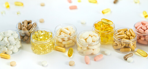 Supplements and vitamins on a white background. Selective focus.