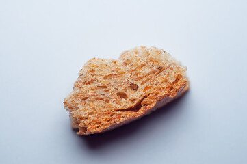 A slice of bread with a smiling face on a white background. Cracker Smile