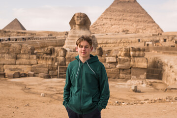 Portrait  of happy tourist  man on background pyramid of Egyptian Giza sunset, Cairo, Egypt.