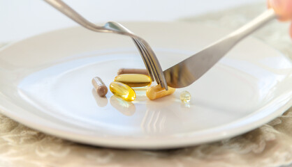 Supplements and vitamins on a plate. Selective focus.
