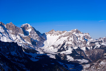 Aerial view of mountain panorama at the Swiss Alps seen from ski resort Engelberg, focus on...
