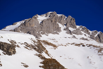 Aerial view of mountain panorama at the Swiss Alps seen from ski resort Engelberg, focus on background. Photo taken February 9th, 2022, Engelberg, Switzerland.